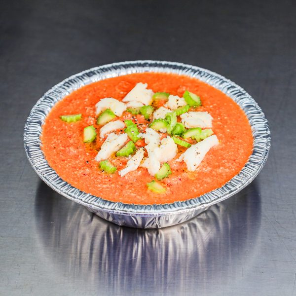 Chilled gazpacho soup with tomato paste, mozzarella, and celery slices.