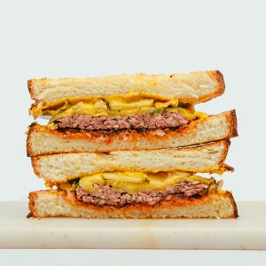 Patty Melt with juicy beef patty, melted cheese, and toasted brioche bun.